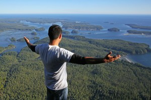 Eli Ens, the co-director of Tla-o-qui-aht First Nation Tribal Parks, embraces his people’s Ha’huulthii — traditional territory — from the top of the Wah-nah-jus (Lone Cone Mountain) at the western edge of the Meares Island Tribal Park. Photograph by Gleb Raygorodetsky. National Geographic - Voices 